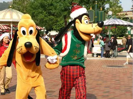 Goofy and Pluto along Main Street during Christmas time